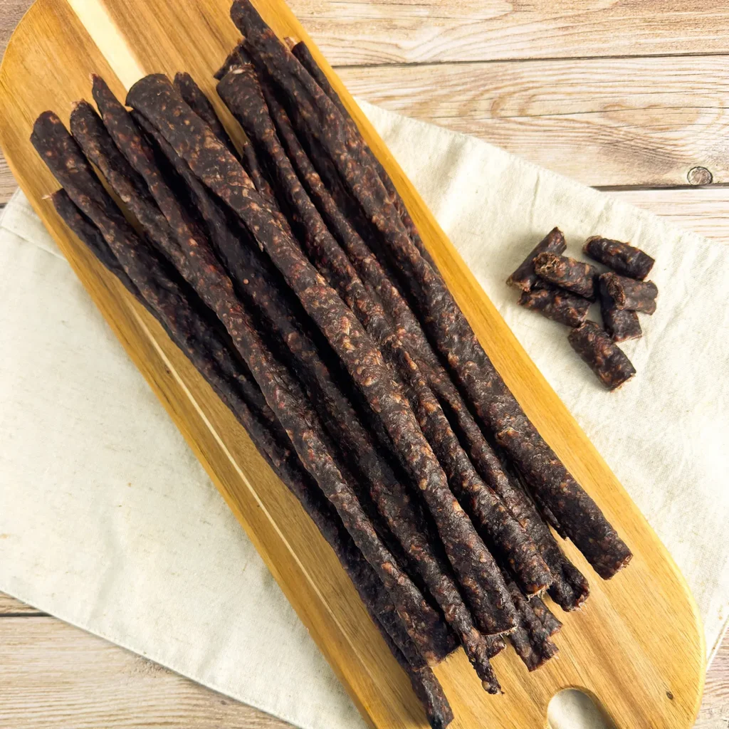 beef droewors pieces on a wood cutting board main image